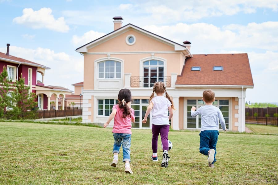 children-playing-by-beautiful-house