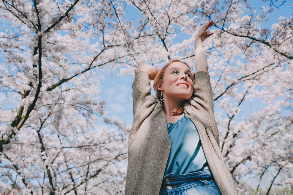 woman-enjoy-life-and-a-beautiful-park-with-cherry